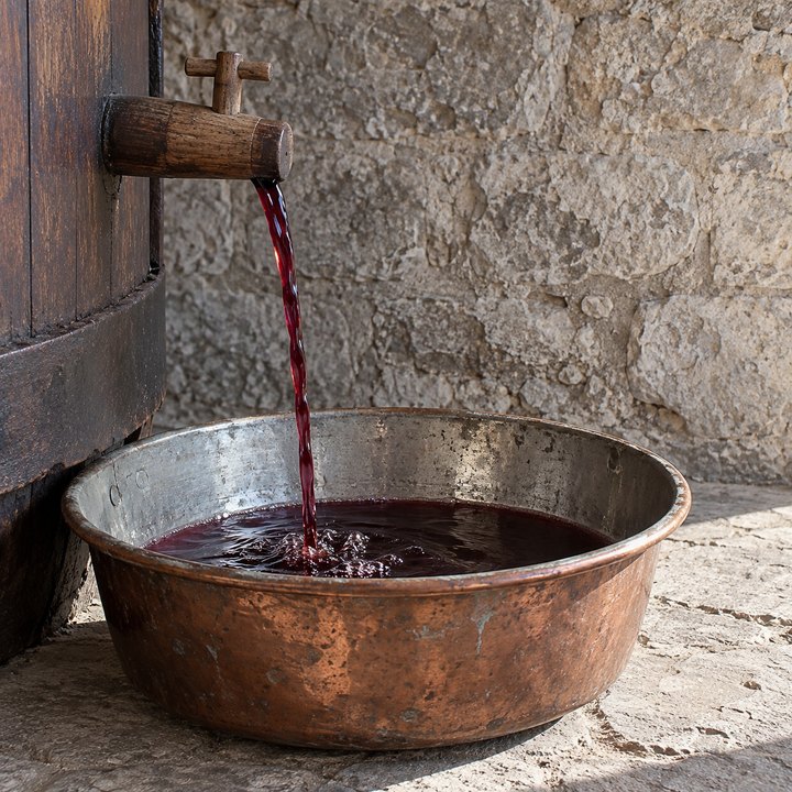 The free-run wine flows into copper